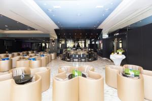 a lobby with a row of chairs and a bar at Gloria Palace San Agustín Thalasso & Hotel in San Agustin +90 photos