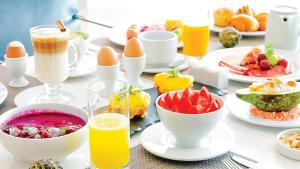 a table filled with breakfast foods and drinks at InterContinental Luanda Miramar, an IHG Hotel in Luanda
