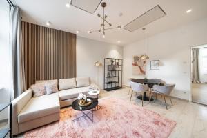 a living room with a couch and a table at ZEUS Design Apartments in Vienna