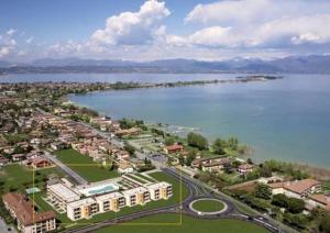 an aerial view of a city next to a body of water at Gardappartamenti Benacus Sirmione in Sirmione
