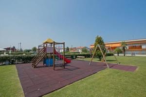 a playground with a slide and a swing set at Gardappartamenti Benacus Sirmione in Sirmione +27 photos