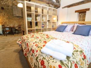 a bedroom with a bed with towels on it at The Forge at Smithy Cottage in Bloxham