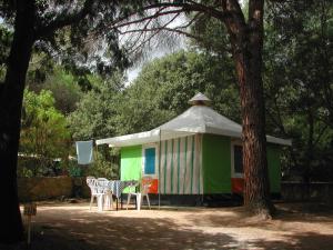 a tent with a table and chairs in front of it at Camping Paduella in Calvi +12 photos