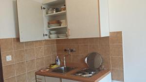 a kitchen with a sink and a counter top at Apartments Vidović in Vodice