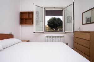 a bedroom with a white bed and a window at M278 - Marcelli, delizioso bilocale con terrazzo in Marcelli