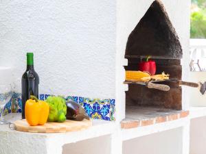 a bottle of wine and some vegetables on a counter at Holiday Home La Cigarra by Interhome in Calpe