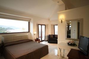a bedroom with a bed and a large window at Hotel Palace 4S in Crotone