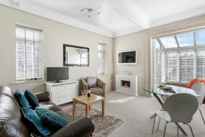 a living room with a couch and a table at The Torcroft Apartments at Bedford House in Torquay