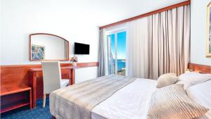Cama o camas de una habitación en Hotel Komodor