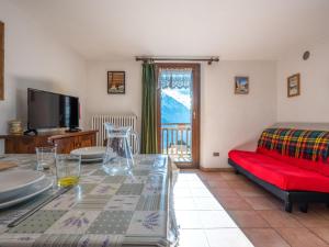 a living room with a table and a couch at Apartment Grand Sarriod-5 by Interhome in Saint Nicolas