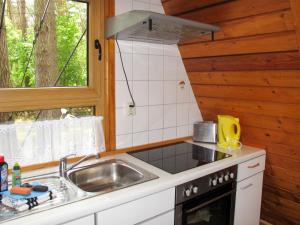 a kitchen with a sink and a stove and a window at Chalet Nepumuk-3 by Interhome in Arendsee