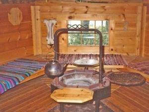 a room with a woodburning stove in a cabin at Holiday Home Ullanlinna by Interhome in Käylä