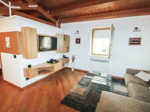 a living room with a couch and a tv at Apartment Romeo by Interhome in Modica