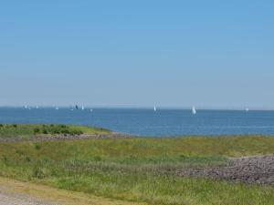 a view of the ocean with boats in the water at Holiday Home Zeeuwse Cottage Wemeldinge-1 by Interhome in Wemeldinge