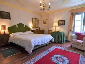 a bedroom with a large bed and a couch at Villa Barchessa Palladio by Interhome in Levada