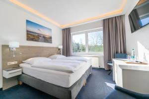 Ένα ή περισσότερα κρεβάτια σε δωμάτιο στο Hotel Mukran