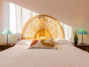 a large white bed with a large wooden headboard at Apartment Marie by Interhome in Torredembarra