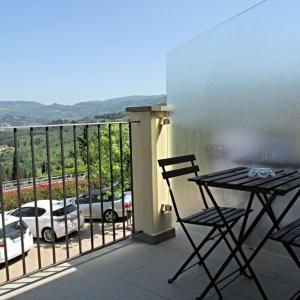 a patio area with chairs and a bench at Residence Fiesole in Fiesole