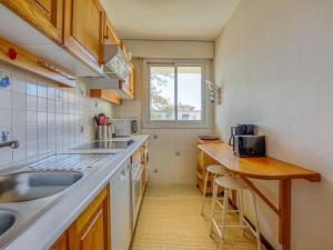 a small kitchen with a sink and a counter at Apartment Les Tamaris by Interhome in Arcachon +13 photos