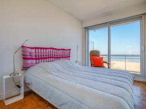 a bedroom with a bed with a view of the ocean at Apartment Les Tamaris by Interhome in Arcachon
