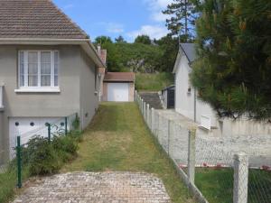 a fence in front of a house with a yard at Villa Villa Les Dunes by Interhome in Le Home Varaville