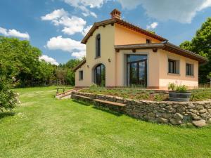 a small house with a stone wall at Holiday Home Il Fienile del Casolare by Interhome in Penna