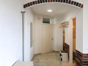 Cette chambre dispose d'un couloir avec une porte et un mur en briques. dans l'établissement Apartment Residenza Monte Bré - Apt-002 Haus1 by Interhome, à Lugano