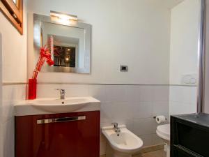 a bathroom with a sink and a toilet and a mirror at Holiday Home Casa Francesca by Interhome in Rosia