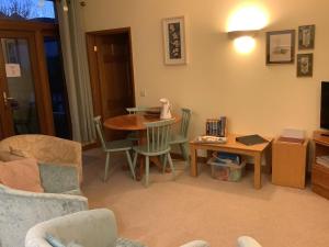 a living room with a table and chairs at polgoon Vineyard annex Penzance in Penzance