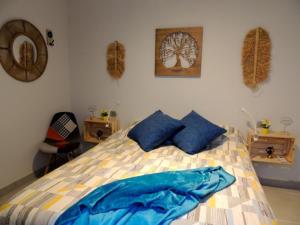 a bedroom with a bed with blue pillows on it at Ocean Rest Canteras Beach & Parking in Las Palmas de Gran Canaria