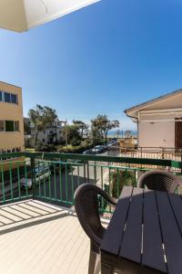 patio con mesa y sillas en el balcón en AD UN PASSO DAL MARE, en Praia a Mare