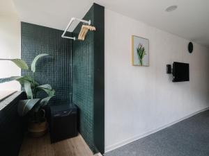 a bathroom with a shower with green tile at Hotel attic in Taipei