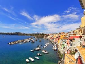 a group of boats in a river with buildings at La Casa Azzurra in Procida