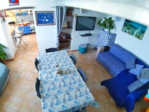 a living room with a blue couch and a tv at La Casa Azzurra in Procida