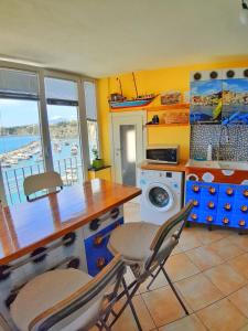 a kitchen with a counter and a washing machine at La Casa Azzurra in Procida