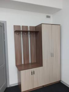 a wooden cabinet in an empty room at BekBro Hostel in Bishkek