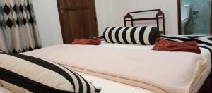 Postel nebo postele na pokoji v ubytování Nethanya Homestay