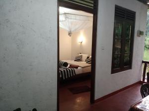 Postel nebo postele na pokoji v ubytování Nethanya Homestay