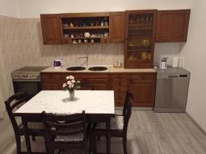a kitchen with a table with a vase of flowers on it at Mimi in Šibenik