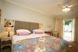 a bedroom with a large bed and a window at Bordeaux Haven Guest House in Vereeniging