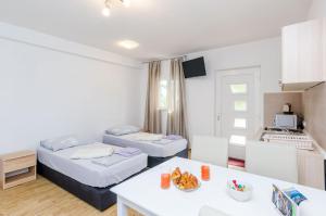 Ένα ή περισσότερα κρεβάτια σε δωμάτιο στο Apartments Dubrovnik Airport