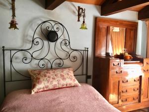 a bedroom with a bed with a metal headboard and a dresser at Attico con Altana in Venice