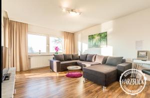 a living room with a couch and a table at Blockhäuser Fewo2 Harzblick in Braunlage