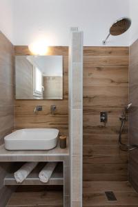 a bathroom with a sink and a mirror at Theodora Rooms in Kamarai