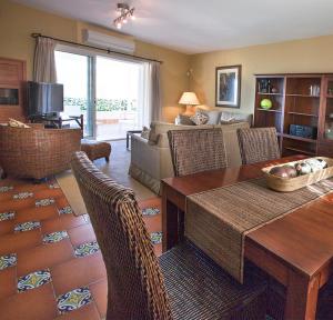 a living room with a table and chairs and a couch at Santa Catalina Home in Málaga