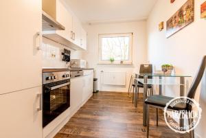 a kitchen with a table and a stove top oven at Blockhäuser Fewo2 Harzblick in Braunlage