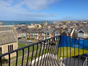 a view of a city from a balcony with houses at The Quies in Newquay