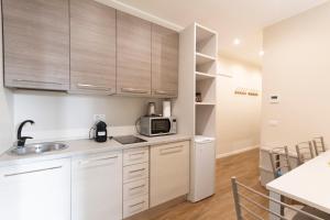 uma cozinha com pia e micro-ondas em Via Torino Apartment 2 em Milão mais 25 fotografias