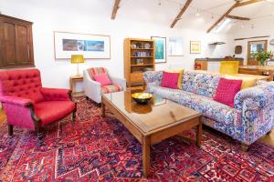 a living room with two couches and a coffee table at The Hayloft in Kings Cliffe