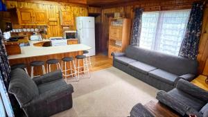 a living room with a couch and a kitchen at 16 Dune Park in Keurboomstrand